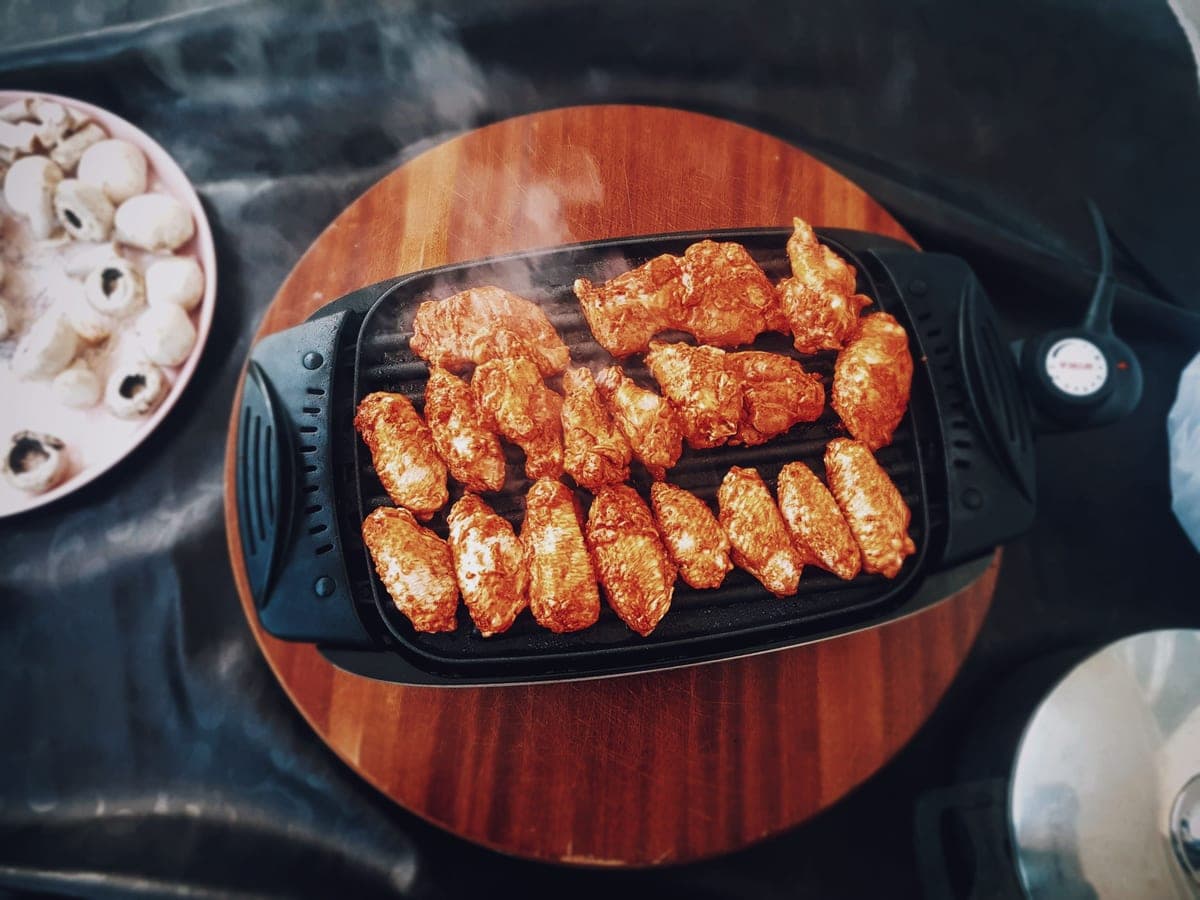 Grilling tools and accessories arranged on a dark surface